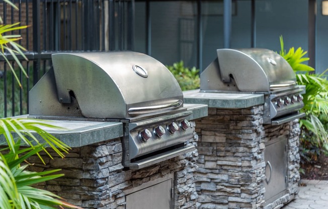 two bbq pits in the backyard of a house