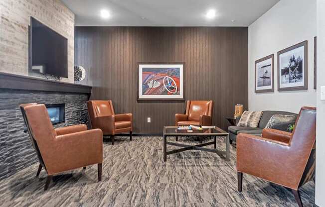 A living room with a fireplace and a painting on the wall.