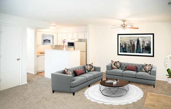 A living room with grey couches and a coffee table.