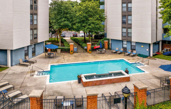 an aerial view of a swimming pool and spa in the courtyard of a hotel building