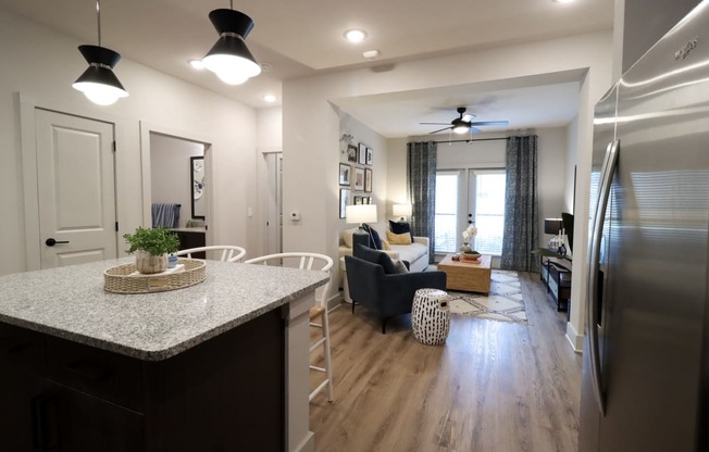 a kitchen with a counter top and a living room