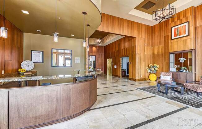 A reception area with a wooden wall and a curved reception desk.