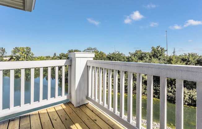 A white railing overlooks a body of water.