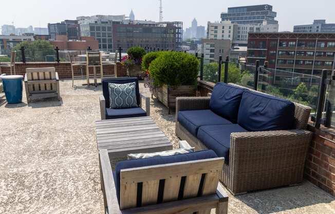 a roof deck with couches and chairs