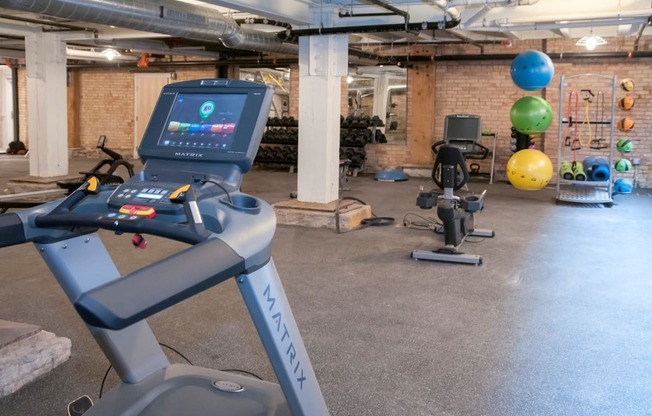 Fitness Center with Multiple Fitness Machines and Materials at 700 Central Apartments, 700 Central Avenue, Minneapolis