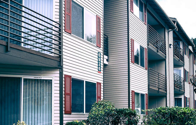 Sitka Heights exterior, paved pathway surrounded by landscaping leading to apartments with patios and balconies.at Sitka Heights, Fife, WA 98424