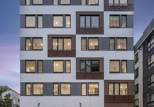 a rendering of an apartment building on a city street with cars parked in front of it