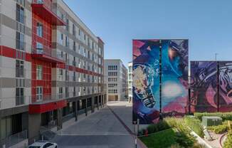 a large mural on the side of a building on a city street