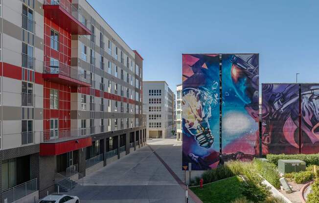 a large mural on the side of a building on a city street