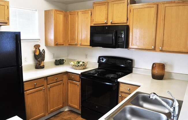 Full Kitchen with Microwave and Dishwasher at Apts in Denver Colorado