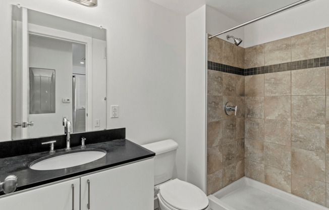 Step into luxury with this elegantly designed modern bathroom, featuring a stylish vanity and spacious shower.