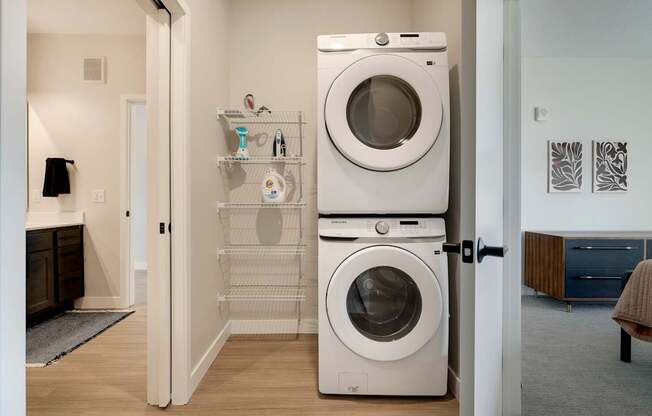A white washing machine and dryer in a laundry room.