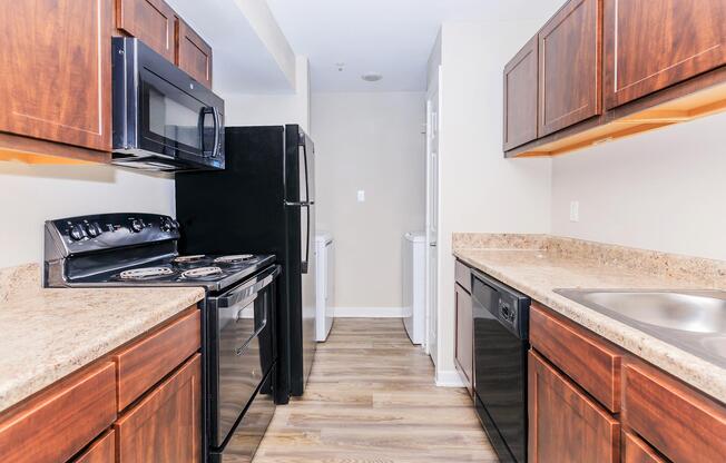 a kitchen with stainless steel appliances and wooden cabinets