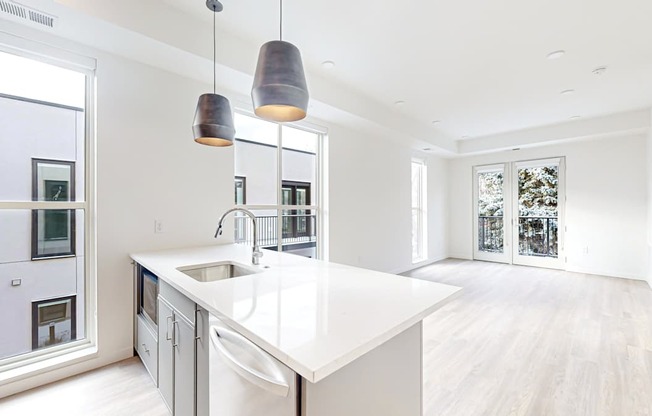 A modern kitchen with a white countertop at One West Drive Apartments, Minnesota, 55331