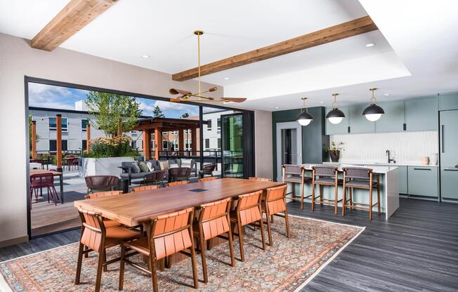 The resident clubhouse features a demonstration kitchen, communal dining space, and seamless indoor-outdoor connectivity to the rooftop terrace, creating a versatile setting for gatherings, events, and everyday socializing.