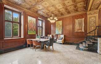 a dining room with wood paneled walls and a table with chairs