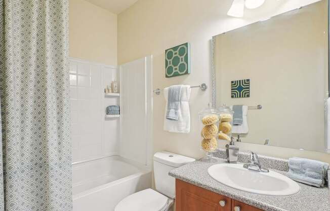 A bathroom with a toilet, sink, and shower.