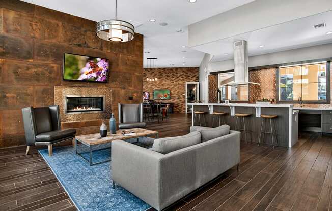 First and Main Apartments clubhouse fireplace lounge area and kitchen breakfast bar
