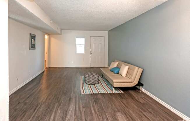 a living room with a couch and a rug