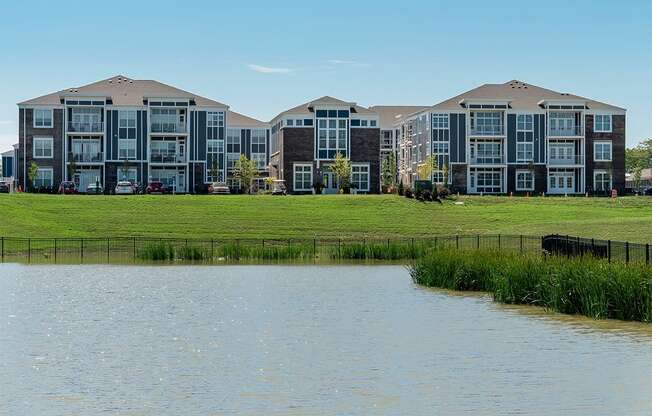 an image of an apartment building overlooking a lake