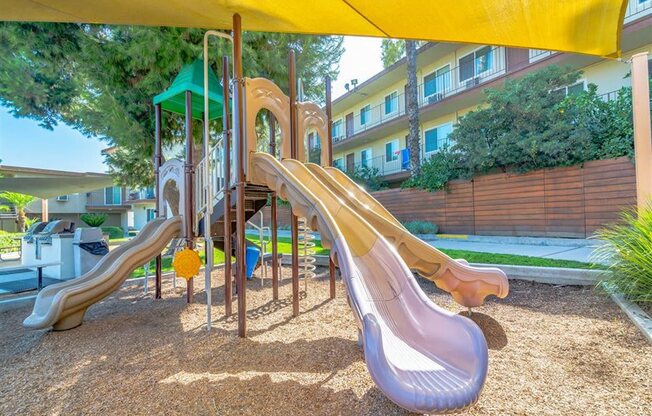 a playground with slides and a swing set