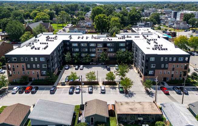 A large building complex with a parking lot in front.
