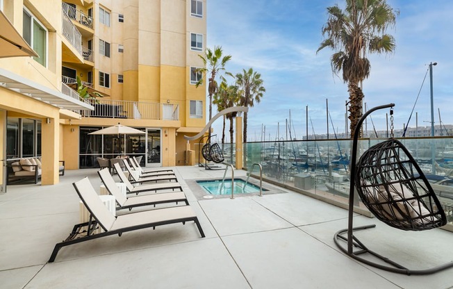 A sunny day at the marina with a building in the background.