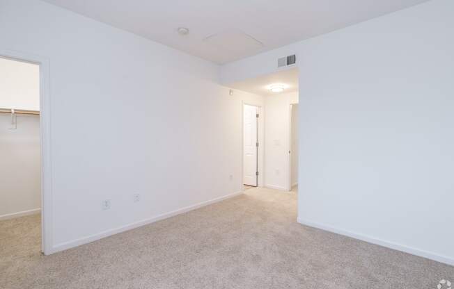 A white room with a carpeted floor and a doorway leading to another room at Cornerstone at Gale Ranch Apartments, San Ramon, CA, 94582