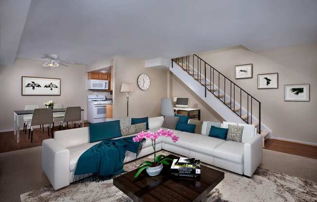 a living room with a white couch and a coffee table