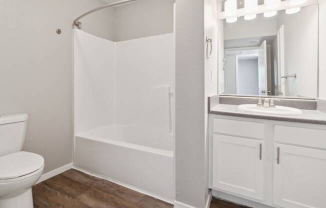a bathroom with a toilet sink and a shower