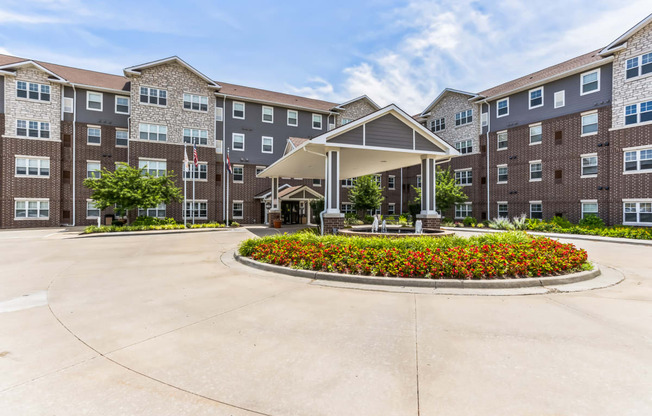 an exterior view of an apartment building with a landscaped courtyard