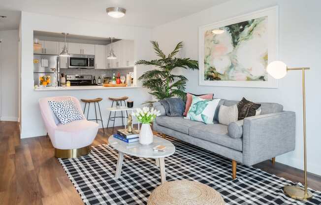 a living room with a couch and a table and a kitchen