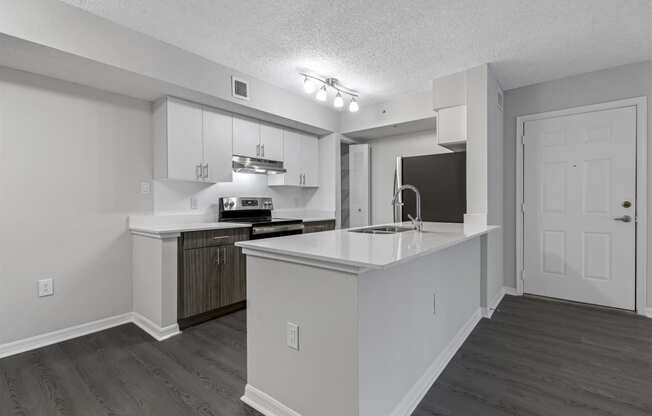 a white kitchen with a large counter top and