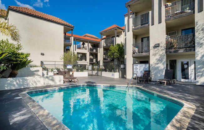 a swimming pool in the middle of two apartment buildings