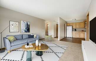 a living room with a couch and a coffee table in front of a flat screen tv