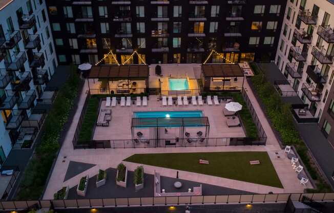 an aerial view of the courtyard of an apartment building with a pool