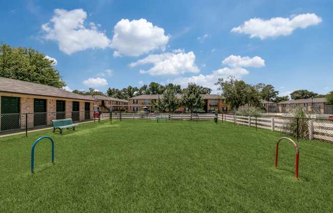 a playground in the backyard of a fenced in yard