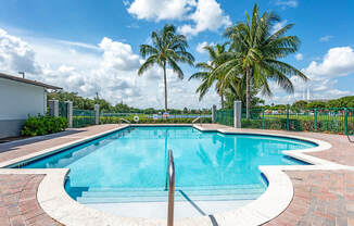 Swimming Pool and Lake View at Cedar Grove Apartments in Miami Gardens FL