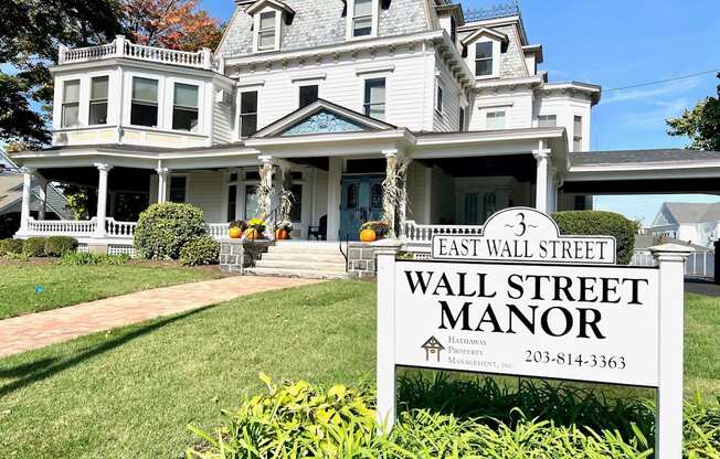 a large white house with a sign that reads wall street manor