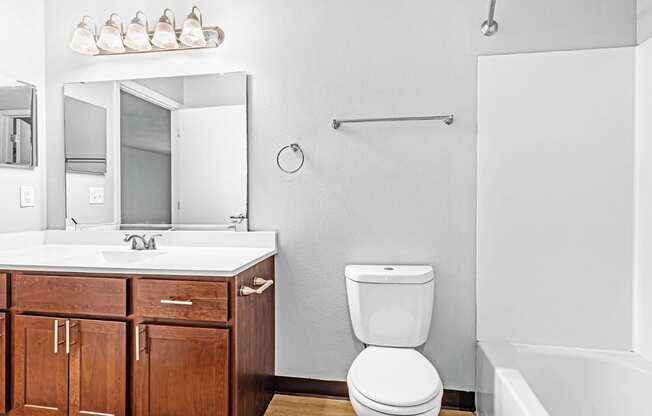 A white toilet sits next to a sink in a bathroom.