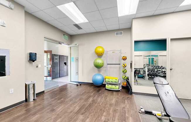 A gym room with a variety of exercise equipment.