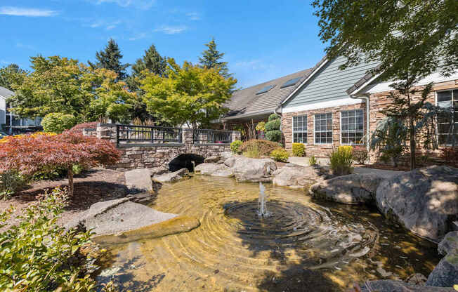 Leasing office entryway pond with a fountain in the middle at Clackamas Trails Apartments, Oregon, 97222