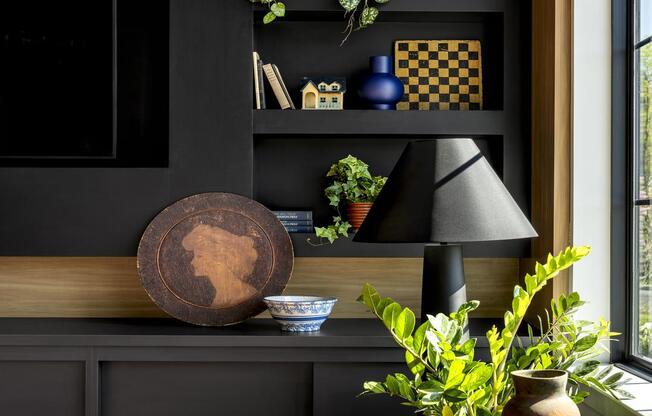 a living room with a black wall and a table with plants