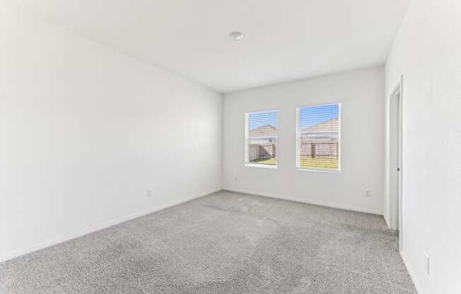 Spacious bedroom with ample natural light of Dogwood floor plan at Beacon at Presidential Heights in Manor, TX