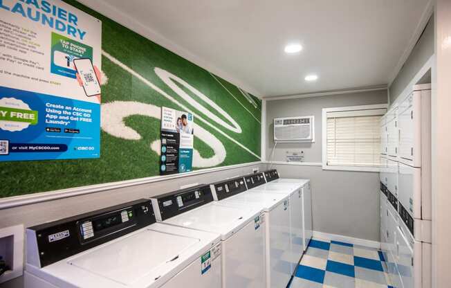 Community laundry room at Stadium 700 apartments with tile floors and many washers and dryers