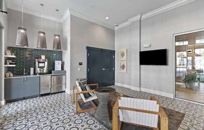 a lounge with a coffee bar and a table and chairs