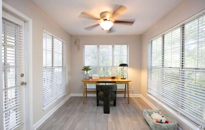 A sunny room with a table and chairs.