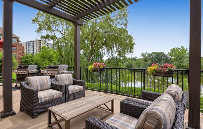 a patio with furniture and a view of a river