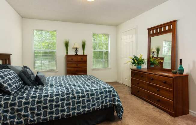 Bedroom with carpet flooring and windows at Regency Gates in Mobile, AL