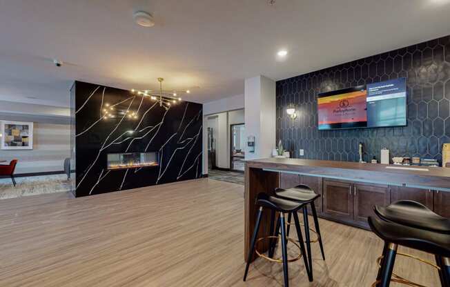 a room with a bar and a bed in the background